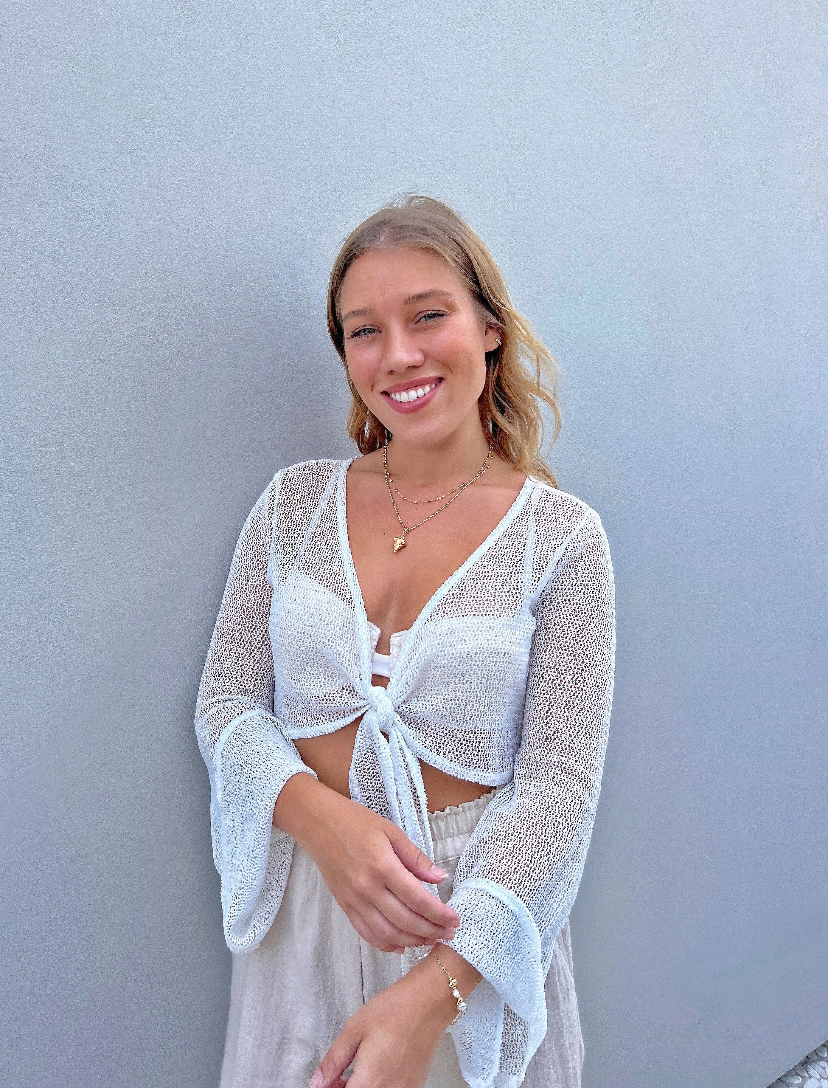 18k gold shell necklace stack on blonde model